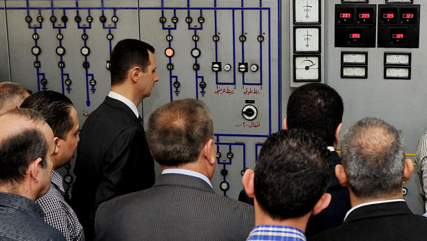 In this photo released by the Syrian official news agency SANA, President Bashar Assad, left, visits the Umayyad Electrical Station on May Day, a day after a powerful bomb hit the capital. in Damascus, Syria, Wednesday, May 1, 2013. (AP Photo/SANA)