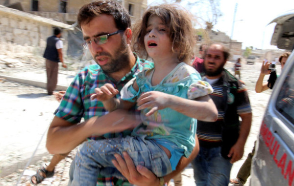 A man carries a girl that survived double airstrikes on the rebel held Bab al-Nairab neighborhood of Aleppo
