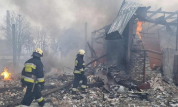 Firefighters try to extinguish a blaze after Russian strikes on Dnipro in east-central Ukraine, March 11, 2022