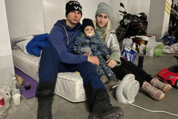 Oleksandr Abramenko with his wife, Alexandra, and their 2-year-old son, Dmitry, in the parking garage of a Kyiv apartment building