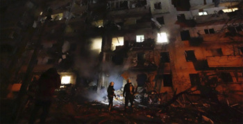 Ukrainian firefighters respond to a Russian rocket attack on a residential building, Kyiv, Ukraine, February 24, 2022
