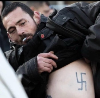 A man shows off his swastika tattoo during a counter-protest against the March for Gaza, London, November 11, 2023 (Hasan Patel)